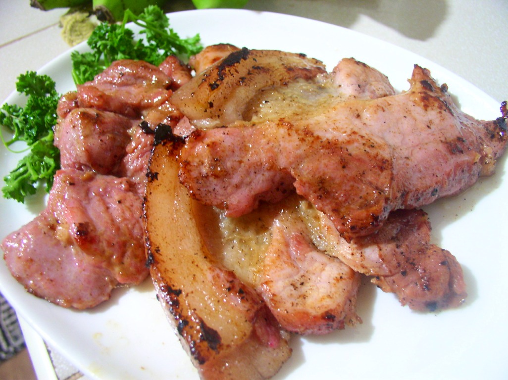 This is sliced ham cooked with some green garnishing.